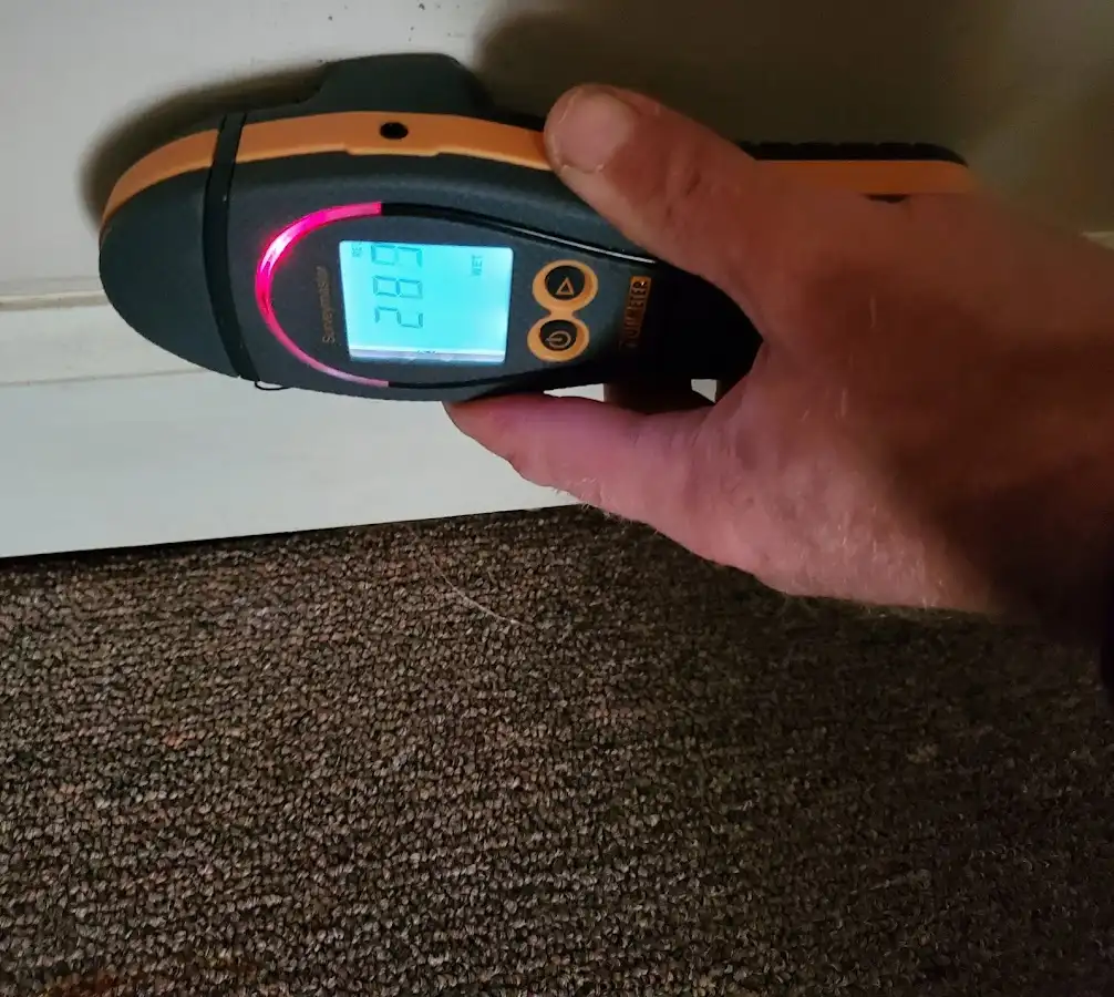 Moisture detection at baseboard during Storm Damage Restoration in Westville